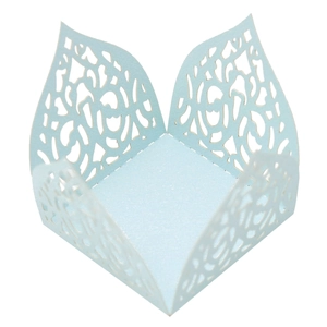 Detail of light blue laser-cut candy box with intricate floral pattern for party decor