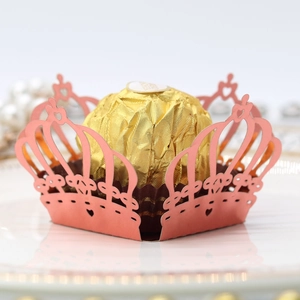 Pink laser-cut crown candy box with intricate heart patterns for wedding party decor