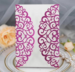 Detail of laser-cut fuchsia glitter wedding invitation shell with heart patterns