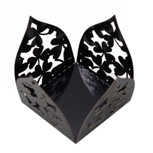 Detail of laser-cut black hollow butterfly pattern on decorative favor box edges