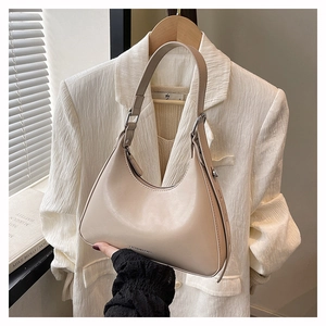 Detail of beige hobo bag with Fashion & Bags logo and visible stitching crafts