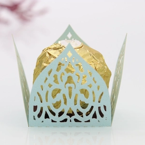 Detail of light blue laser-cut candy box featuring intricate floral hollow patterns
