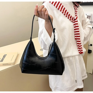 Close-up of black crocodile embossed hobo bag with silver zipper and sleek hobo curve
