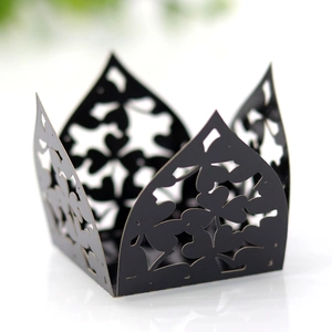 Detail of laser-cut black paper floral lace wrapper for cupcakes or party favors