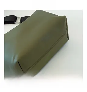 Detail showing army green nylon fabric texture with black woven strap and silver metal ring