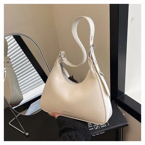Detail of hobo shoulder bag with adjustable strap and fashion lettering on matte leather
