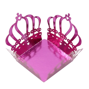 Close-up of laser-cut crown candy box with metallic rose pink hollow pattern finish