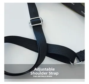 Detail of adjustable black woven strap with polished silver metal buckle on a shoulder bag