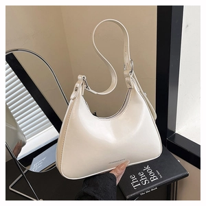 Detail of hobo bag showing creamy white leather texture and FASHION & BAGS logo
