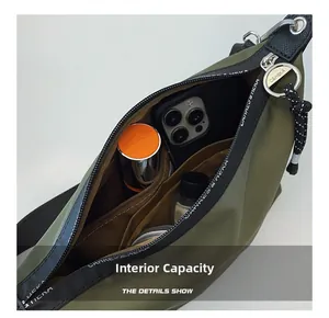 Internal view of the army green crossbody bag showing organized compartments and capacity