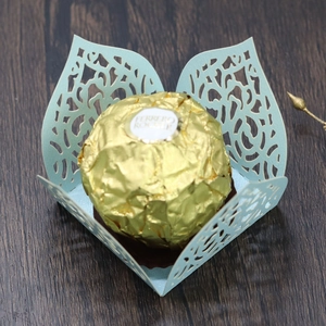 Detail of light blue laser-cut hollow flower candy box with elegant pearlescent finish