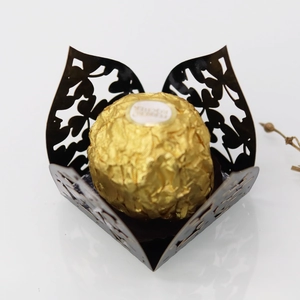 Macro view of laser-cut chocolate wrapper with elegant hollow floral patterns