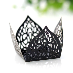 Detailed laser-cut black lace patterns on paper candy box for elegant party decor