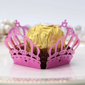 Detailed laser-cut pink crown candy box with heart patterns and gold chocolate display