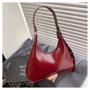 Detail view of burgundy glossy leather hobo bag with Fashion & Bags logo print