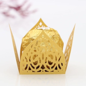 Detailed close-up of golden laser-cut lace candy box with intricate floral patterns