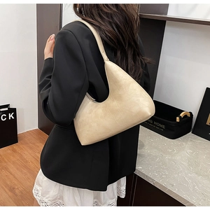 Minimalist beige crocodile pattern shoulder bag shown on model for size and style reference