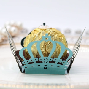 Detailed laser-cut crown hollow chocolate wrapper in cyan blue with intricate heart patterns