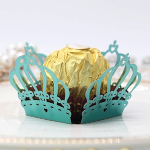 Macro shot of tiffany blue laser cut crown paper wrap for chocolates and cupcakes