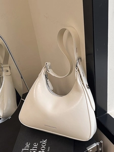 Chic beige underarm bag in glossy faux leather with a minimalist semi-circular design