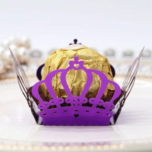Macro shot of laser-cut purple crown hollow paper chocolate box for party decoration