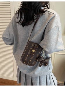 Deep brown crossbody phone bag with cute teddy bear print and small puppy charm