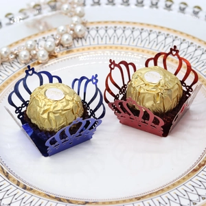 Detail of laser-cut crown chocolate wrappers in blue and red mirror finish paper