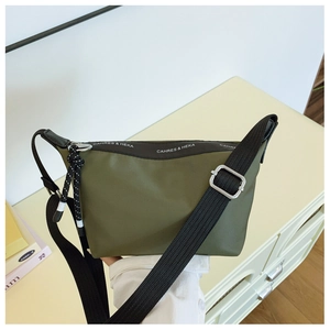 Detail of army green nylon dumpling bag with adjustable strap and logo printing