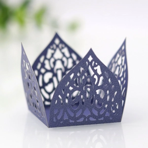 Close-up of laser-cut hollow lace candy box in deep purple with crown floral pattern