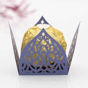 Macro shot of dark purple laser-cut lace chocolate wrapper with golden foil truffle detail