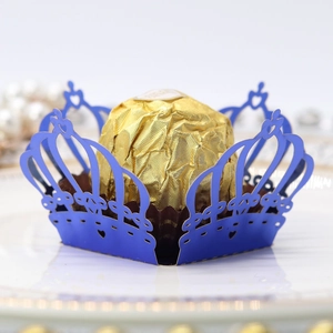 Macro shot of laser-cut crown-shaped navy blue candy box with pearl paper finish