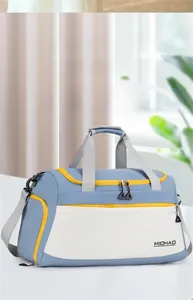 Close-up of large blue fitness bag with yellow zippers and waterproof compartments