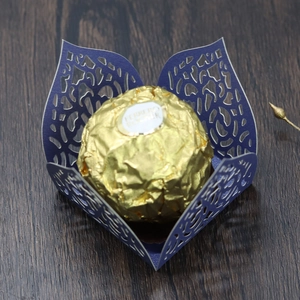 Close-up of laser-cut purple paper chocolate holder for wedding party dessert decor