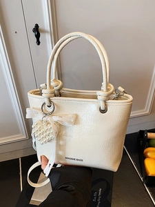 Chic cream white pleated leather bucket bag with knot handle and pearl heart charm