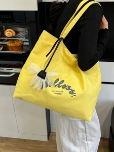 Large yellow canvas tote bag with floral charm and Belloss graphic for summer daily commute
