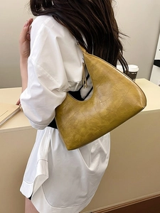 Minimalist olive green croissant shoulder bag with embossed crocodile texture in daily style