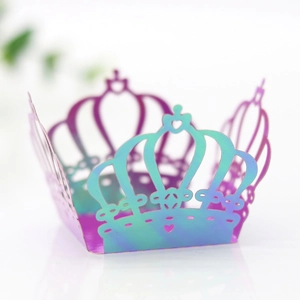 Close-up of laser-cut crown cupcake wrappers with iridescent holographic finish