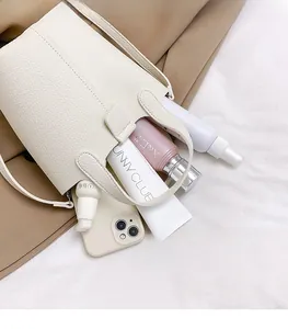 Internal view of a white bucket bag showing large storage capacity for daily essentials