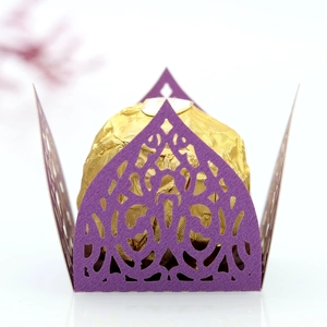Detail of laser-cut purple paper candy box with intricate lace patterns for chocolate