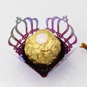 Macro detail of laser-cut crown candy holder in iridescent purple for chocolate decor