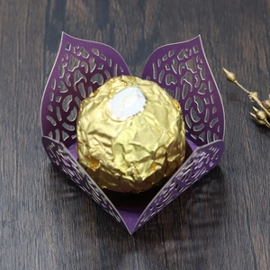 Macro detail of laser-cut purple hollow chocolate box with elegant vine patterns