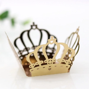 Detailed laser-cut hollow crown design in golden mirror paper with intricate heart patterns