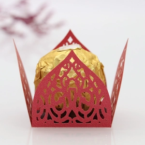 Detailed laser cut red glitter paper wrapper for chocolates with elegant vine patterns
