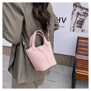Detailed close-up of a pink litchi grain bucket bag with silver metal hardware and straps