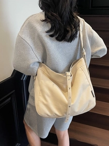 Minimalist beige oversized hobo shoulder bag with adjustable eyelet strap for women