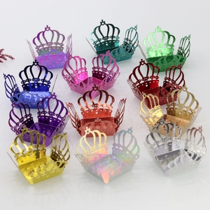 Macro view of laser-cut crown candy boxes in various metallic colors for party favors