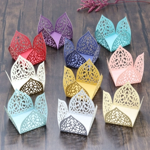 Laser-cut hollow cupcake liners in 10 metallic pearlescent colors on dark wood