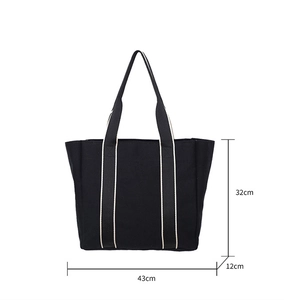 Detailed view of black canvas tote bag showing dimensions 32cm height and 43cm width