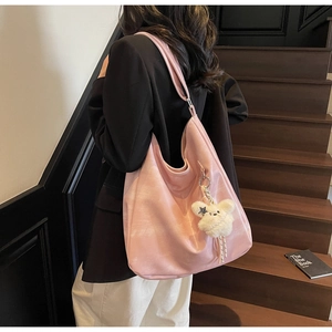 Grand sac cabas rose en similicuir avec charm ours en peluche porté par un mannequin