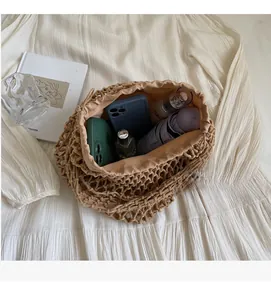 Detail view of woven crochet tote bag with drawstring lining and daily essentials interior